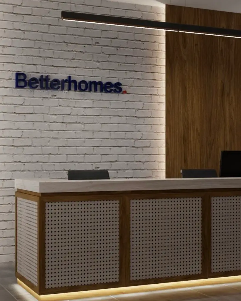 Close-up of the reception desk with perforated panels, a walnut frame and warm under-lighting