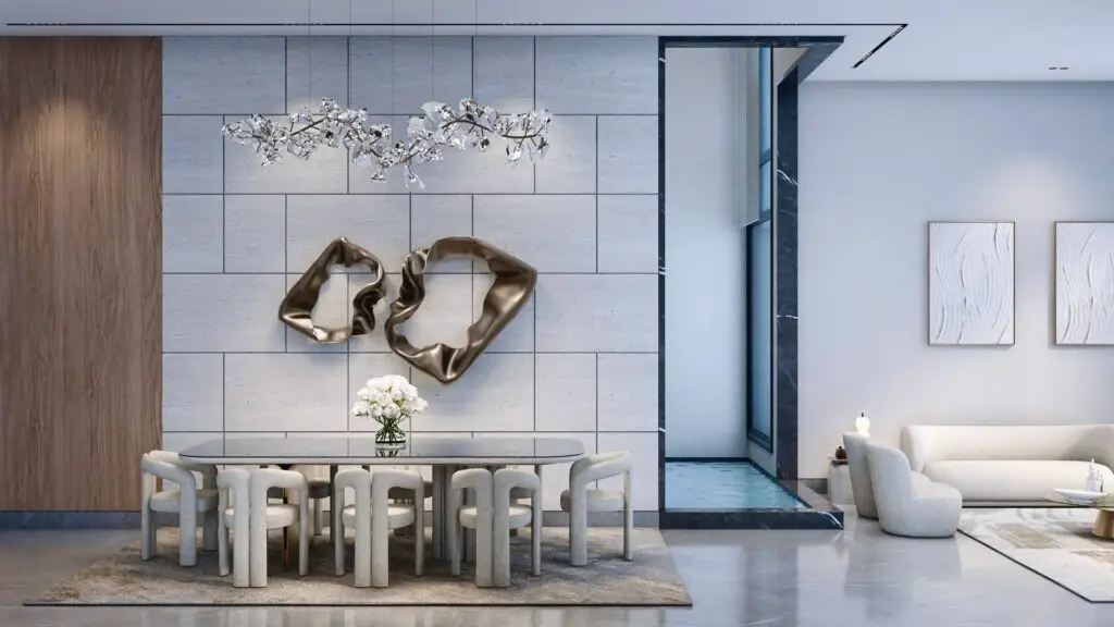 Dining area with cream chairs, a crystal branch chandelier and bronze wall sculptures