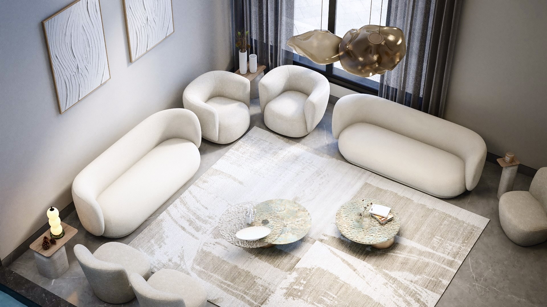 Family lounge seen from above, with cream curved sofas and stone-topped coffee tables